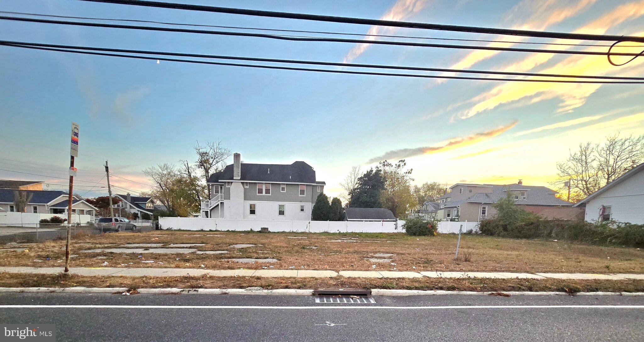 a view of a house with a yard and a street