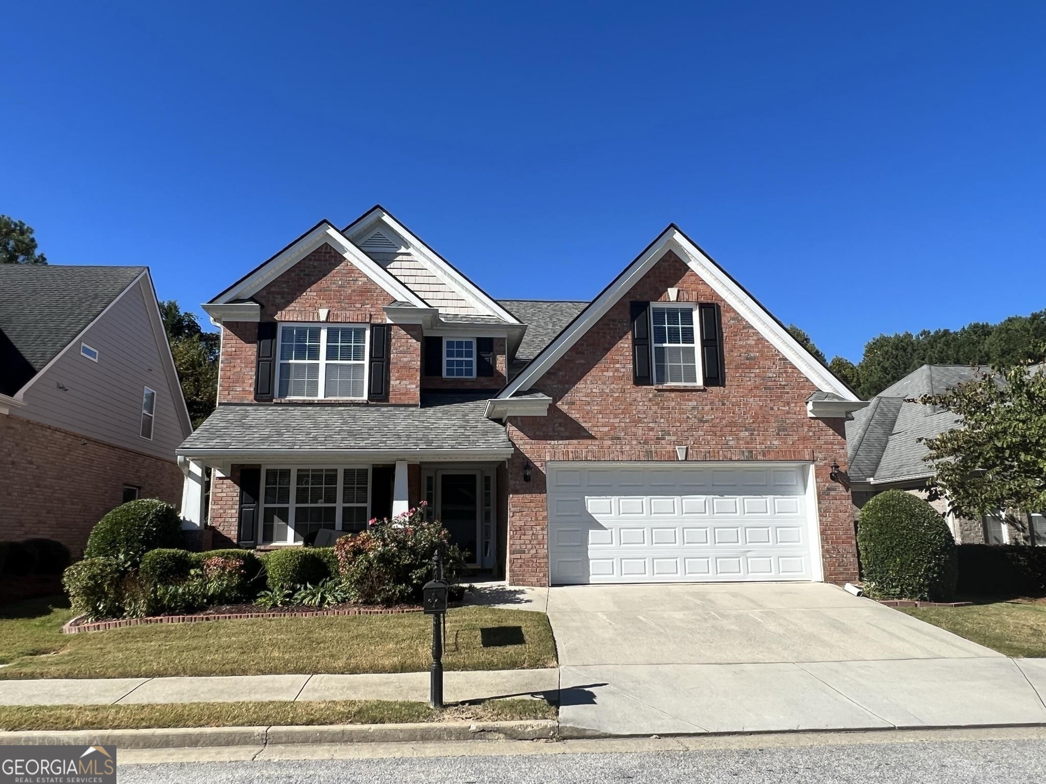 a front view of a house with a yard