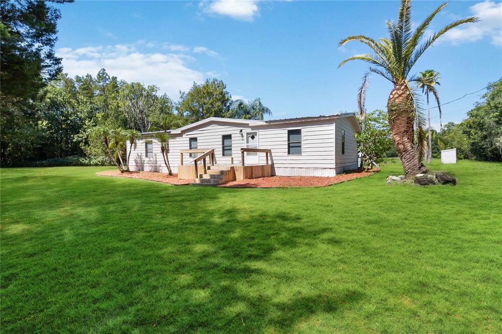 a aerial view of a house with a yard deck and sitting area