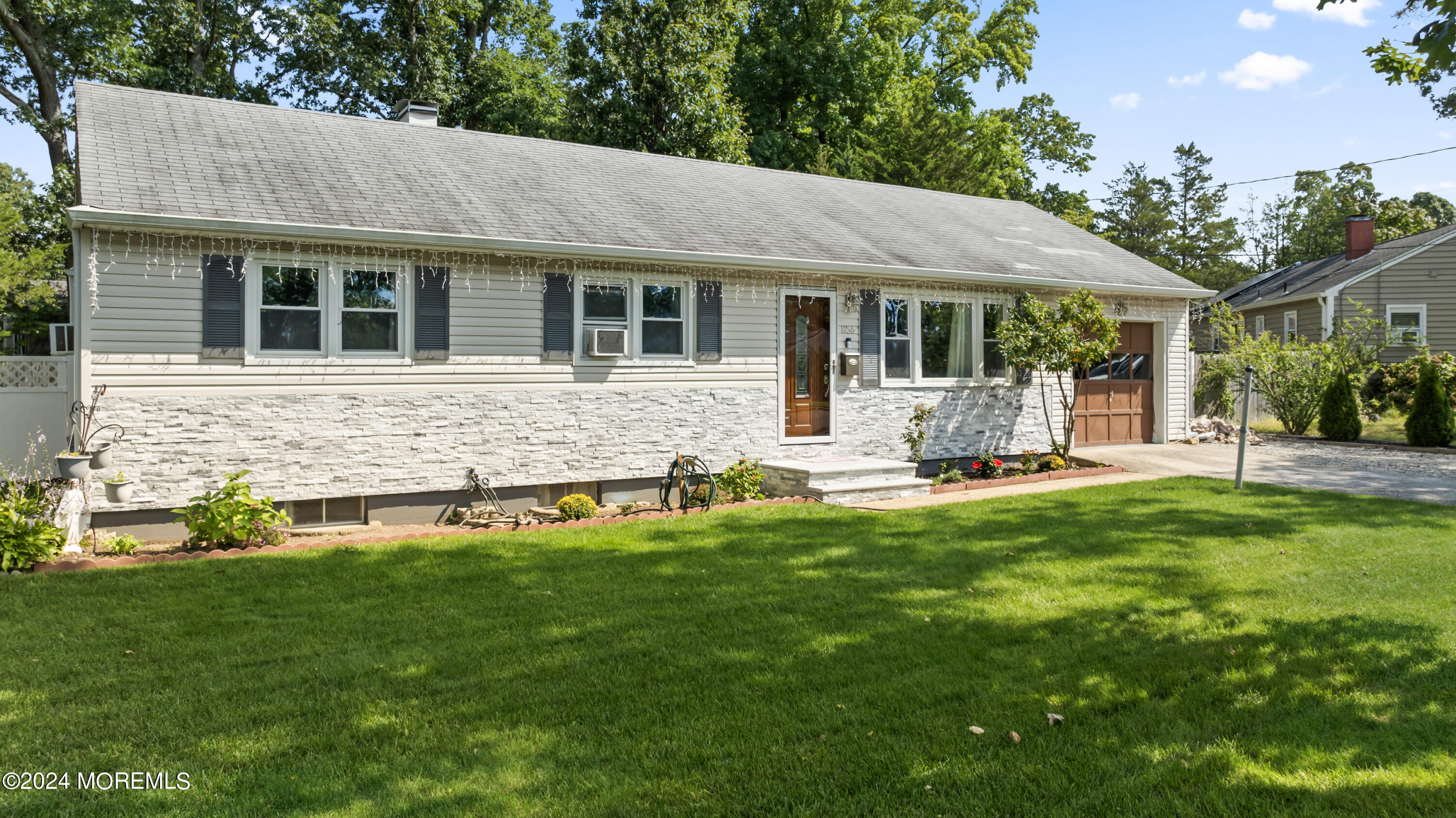 a front view of house with yard patio and green space