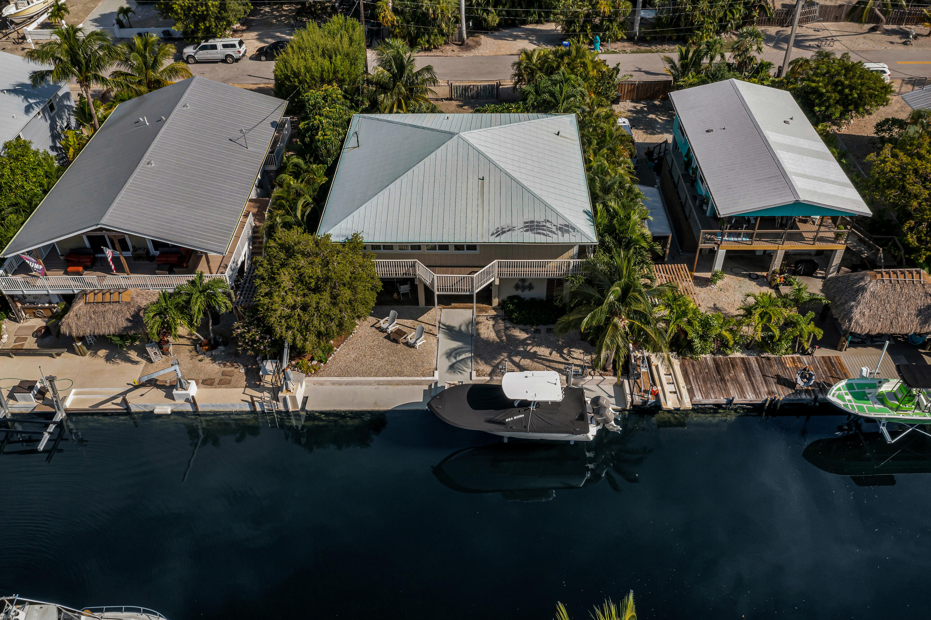 an aerial view of a house with swimming pool and outdoor seating