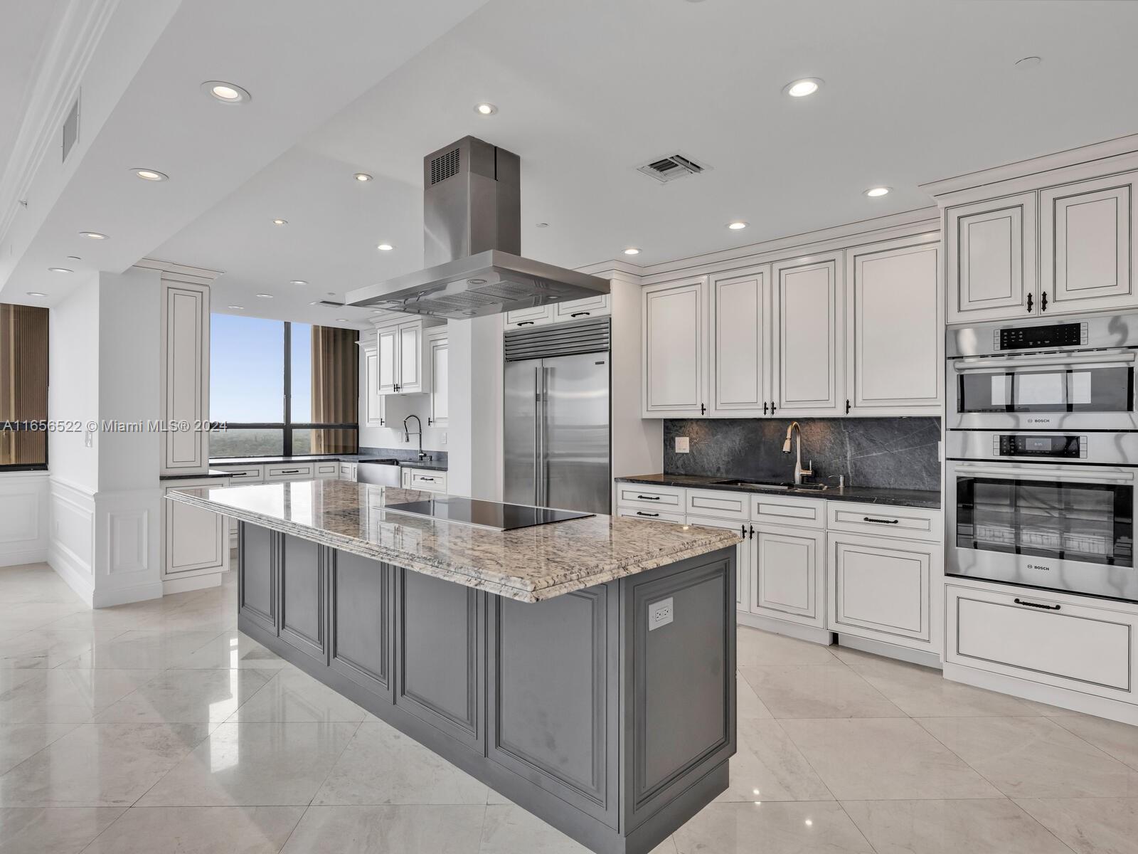 a large kitchen with stainless steel appliances lots of counter space sink and cabinets