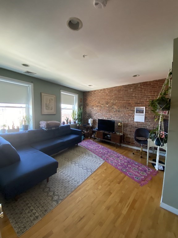 a living room with furniture a rug and a fireplace