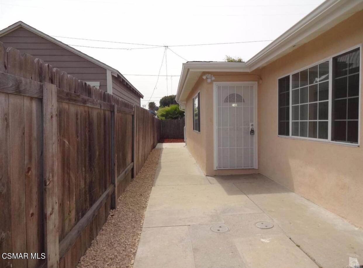 a view of a house with a wooden fence