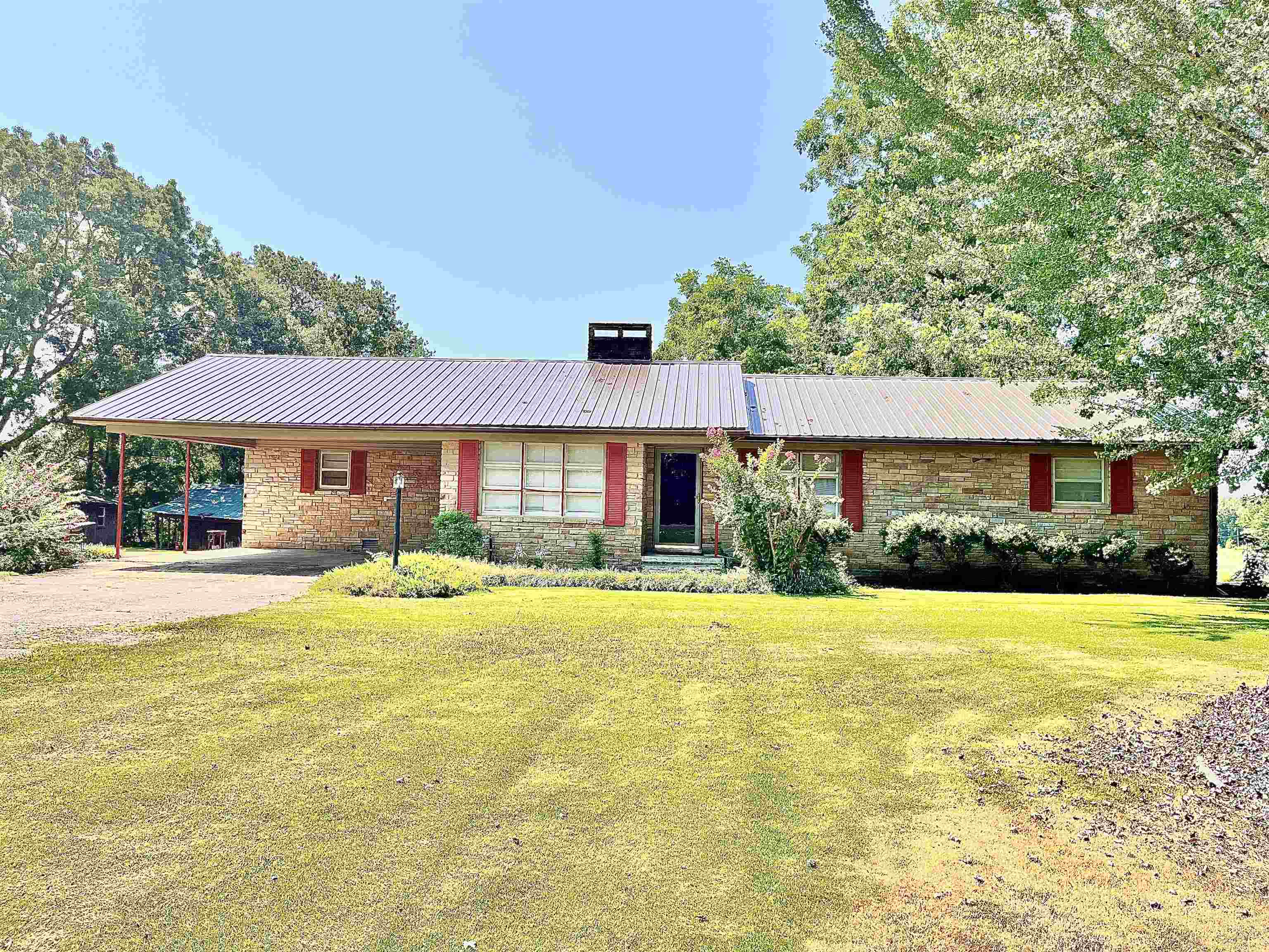 a front view of a house with a yard and swimming pool