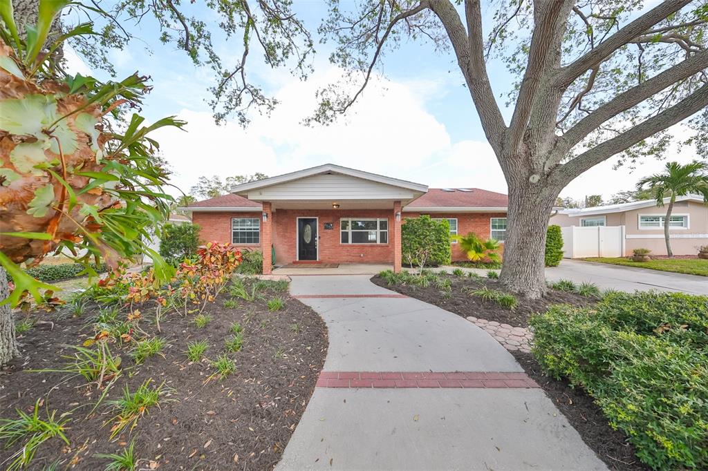 a front view of a house with garden