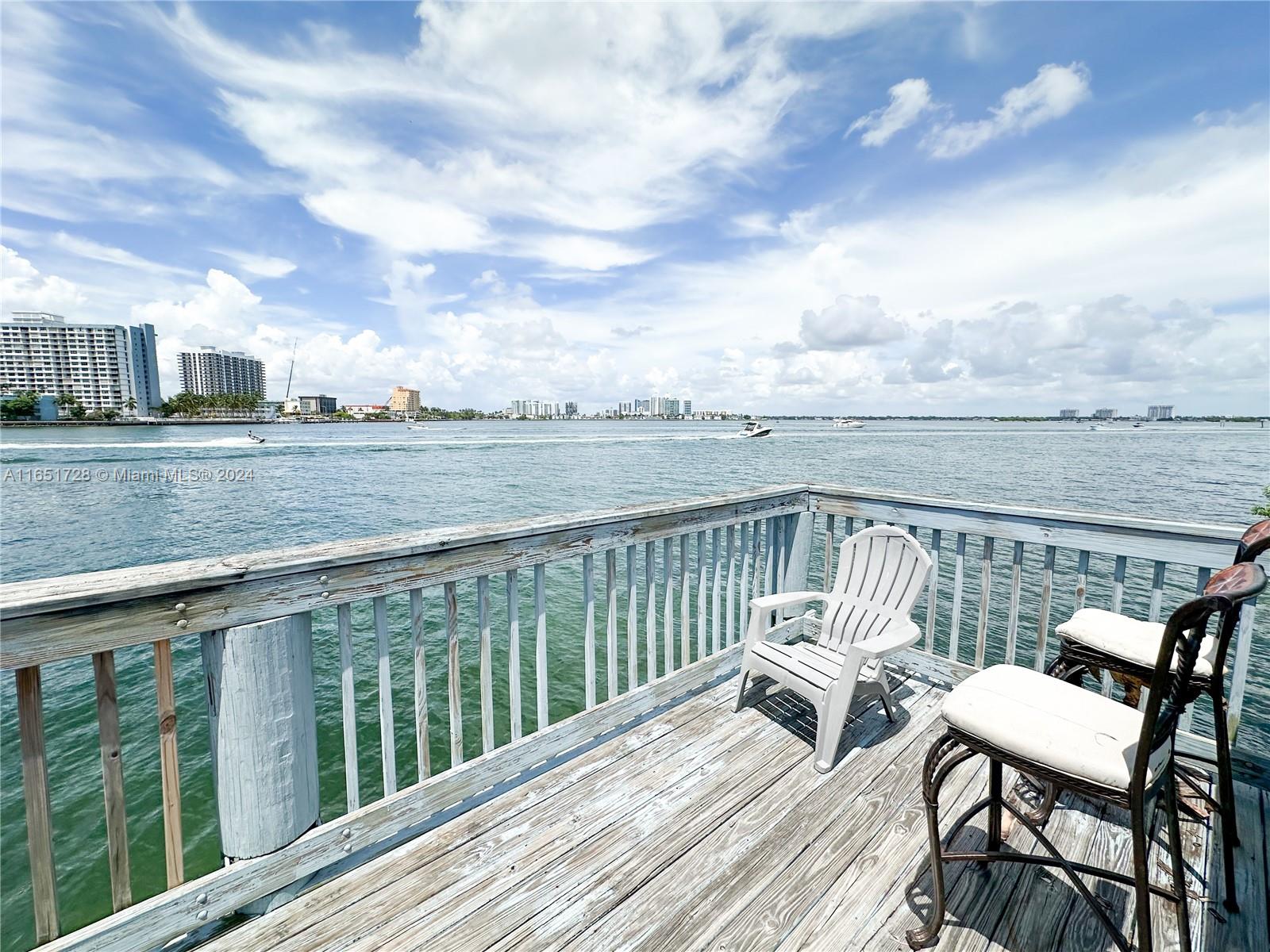 a view of a balcony with wooden benches