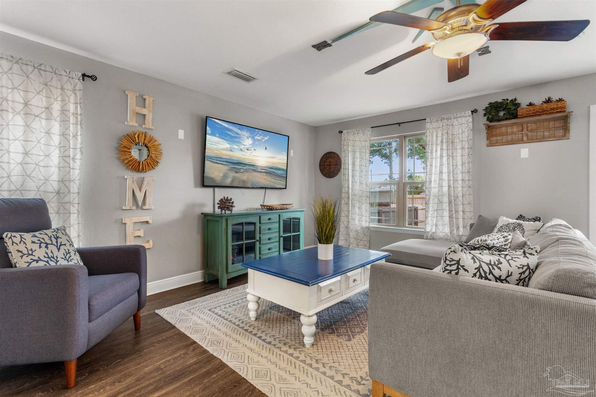 a living room with furniture and a flat screen tv