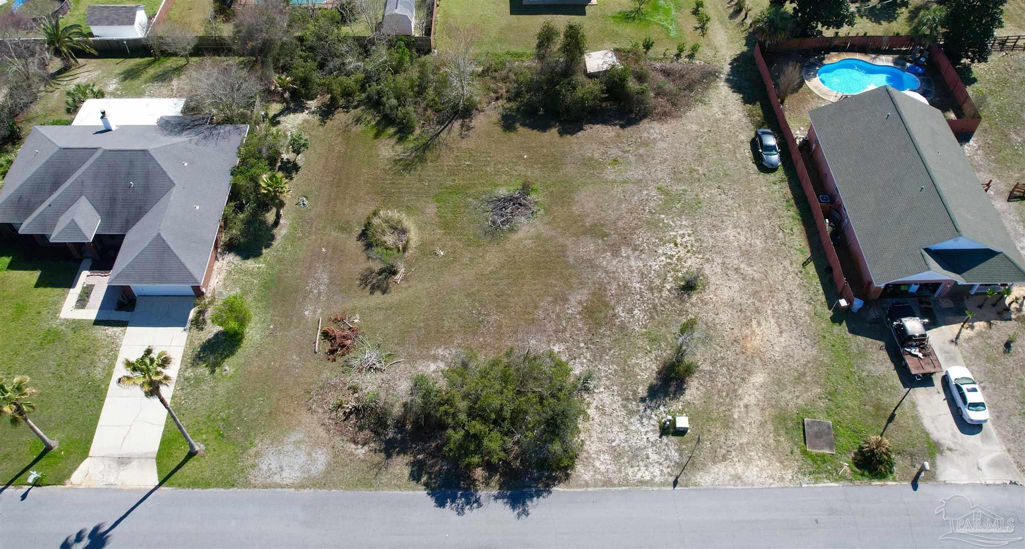 an aerial view of a house with a yard