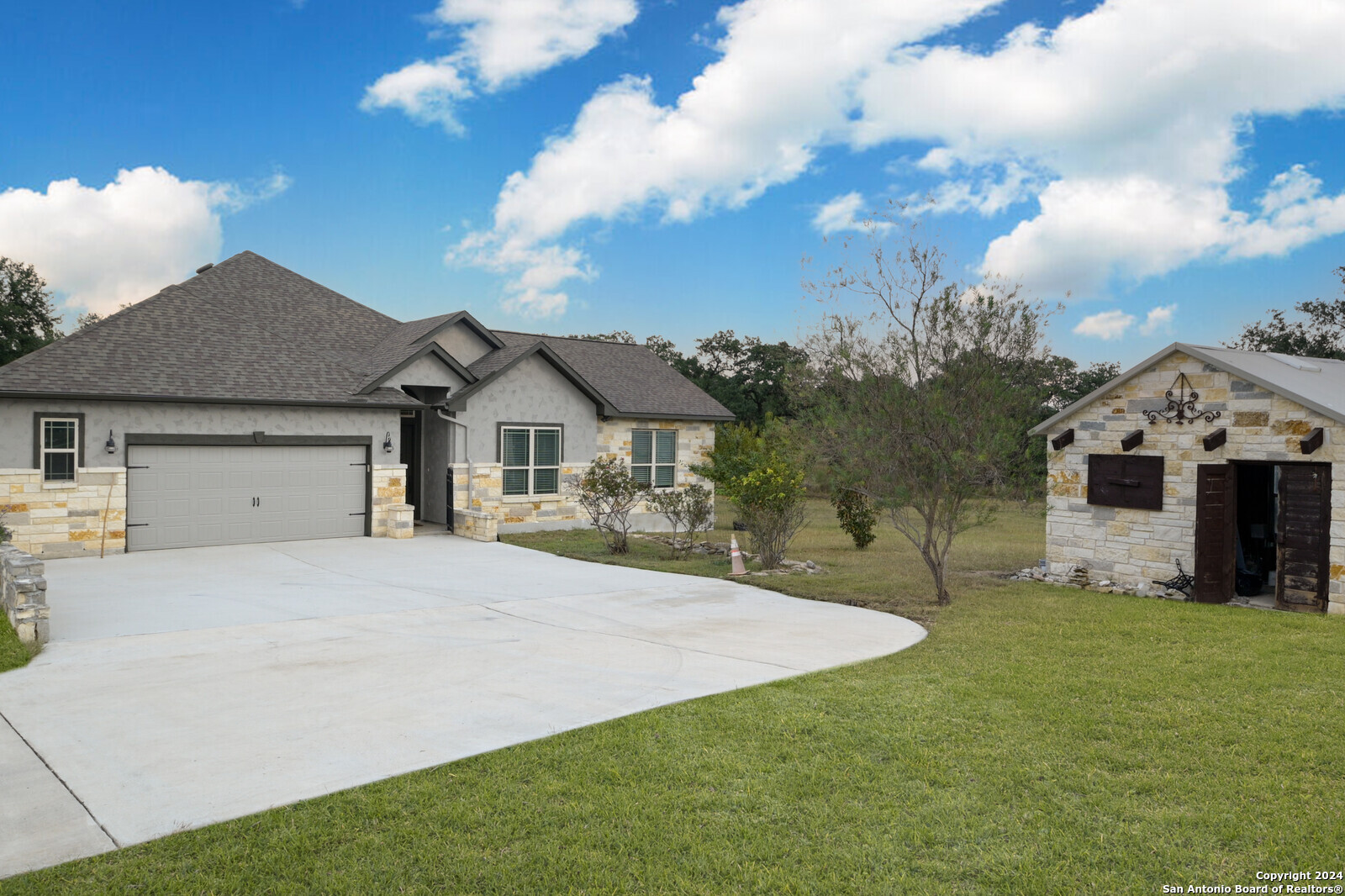 a front view of a house with a yard and garage