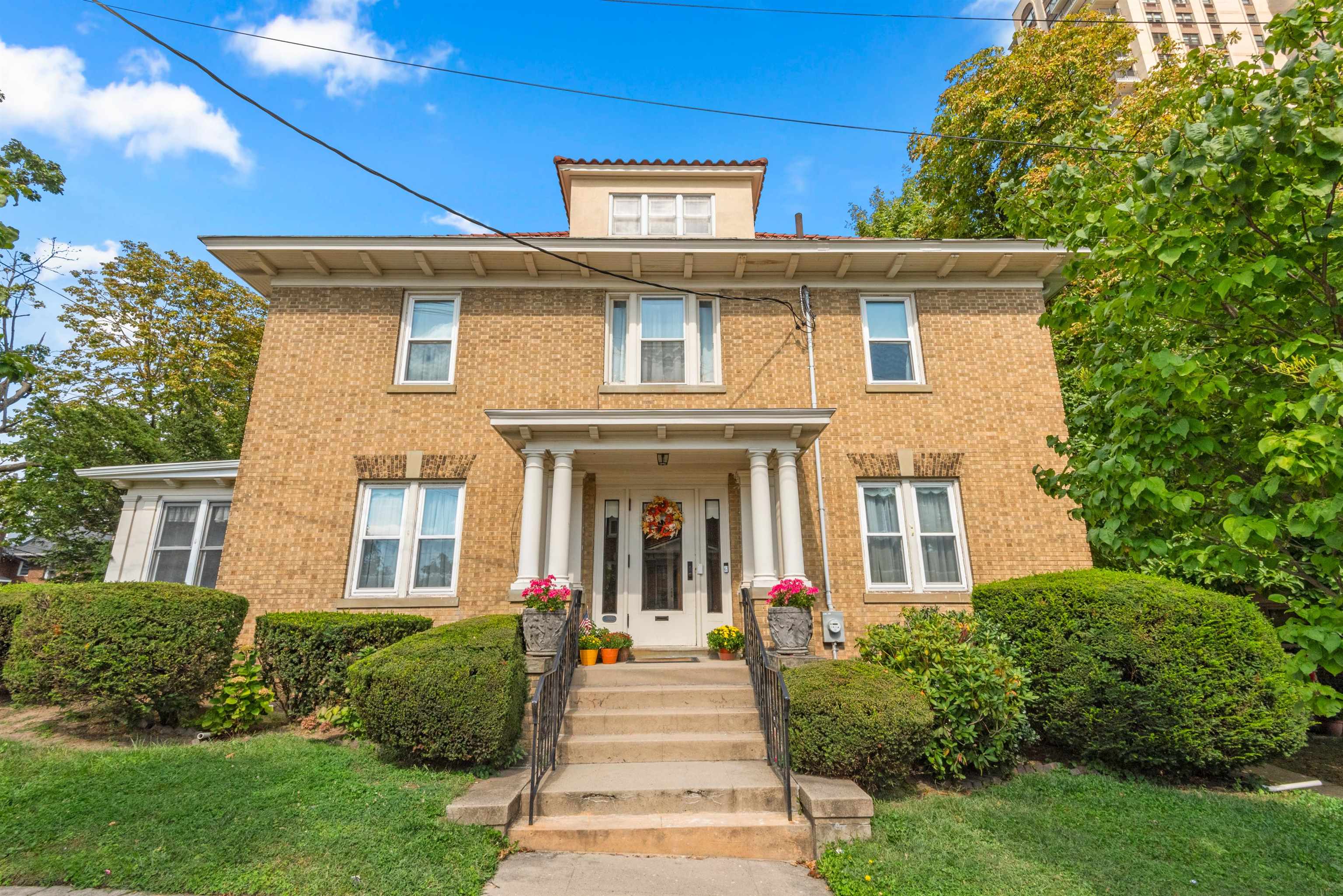 a front view of a house with a garden