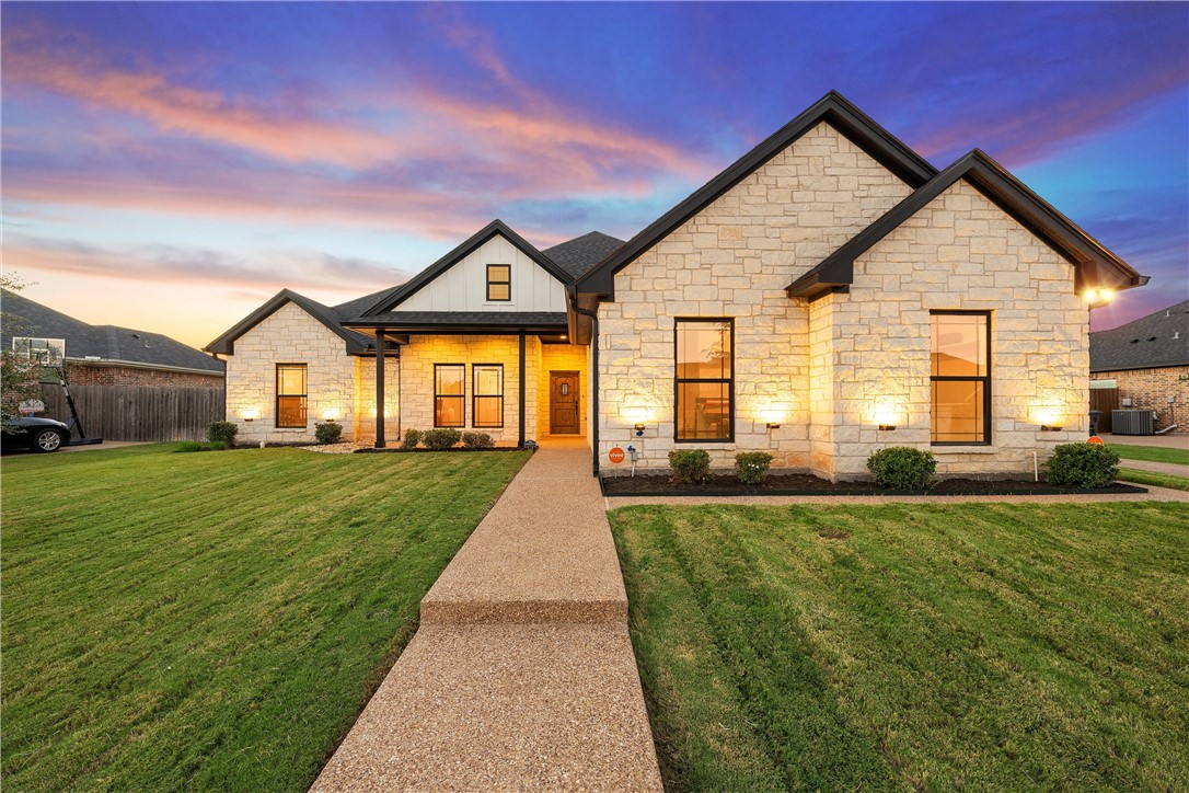 a view of a house with a big yard and pathway