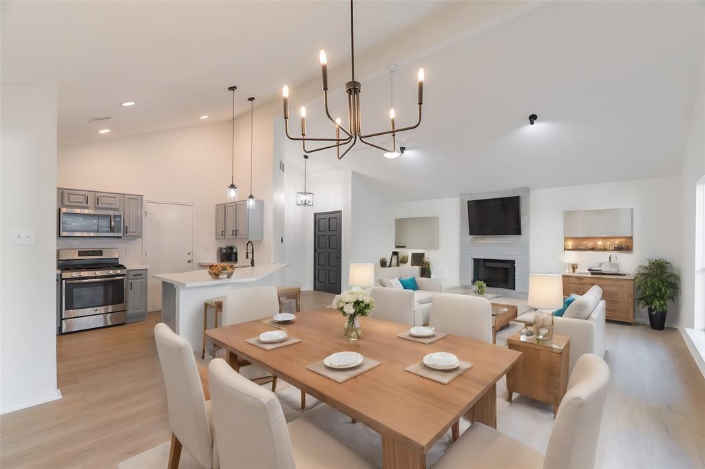 a large kitchen with a table and chairs