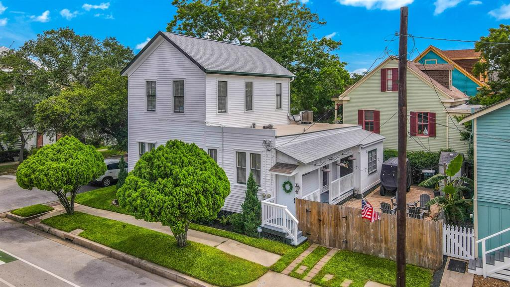 a aerial view of a house with yard and potted plants