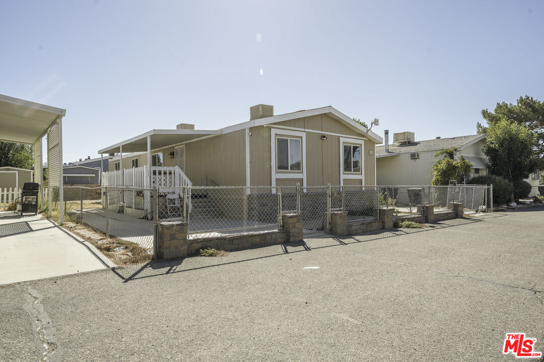 a view of a house with barbeque grill and a view of outdoor space