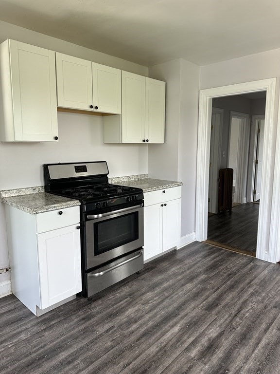 a kitchen with granite countertop a stove and a sink