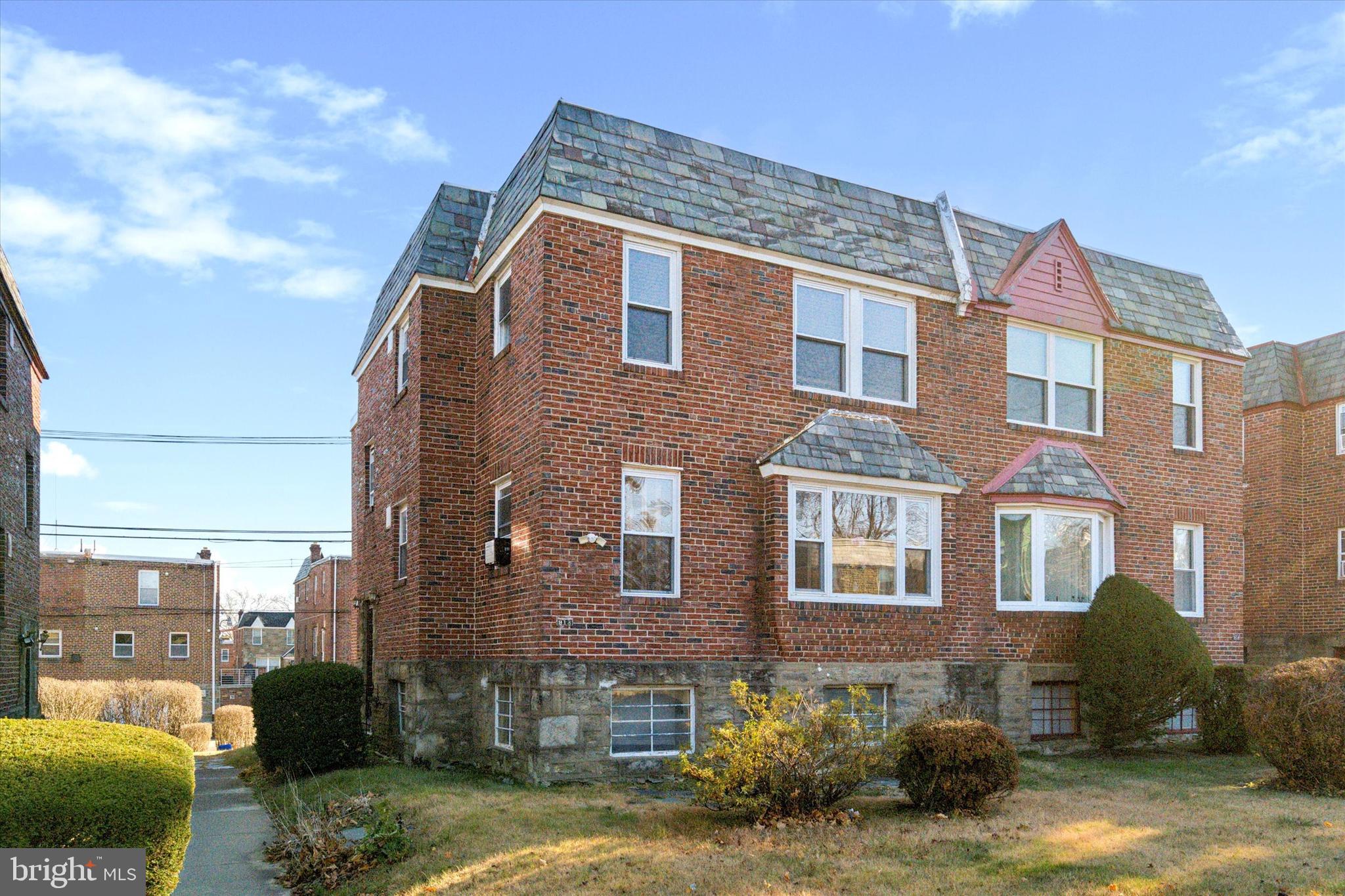 a view of a brick building next to a yard