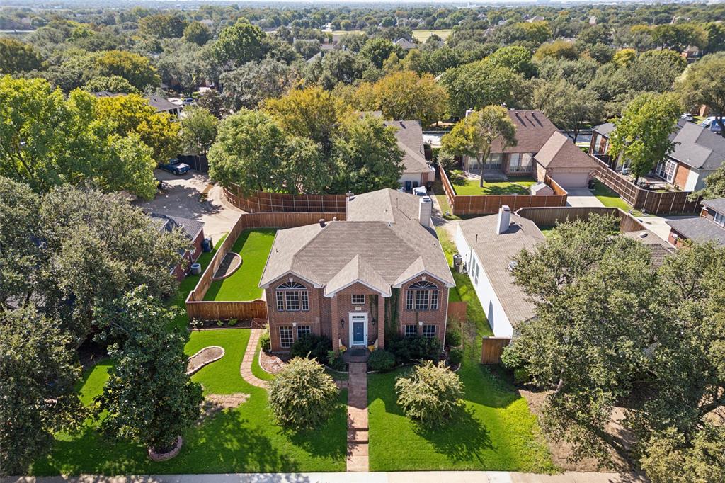 an aerial view of a house with a swimming pool outdoor seating and yard