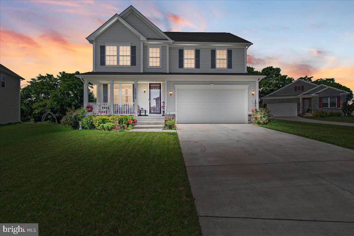 a front view of a house with a garden and plants