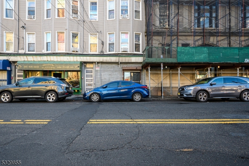 a couple of cars parked in front of a building