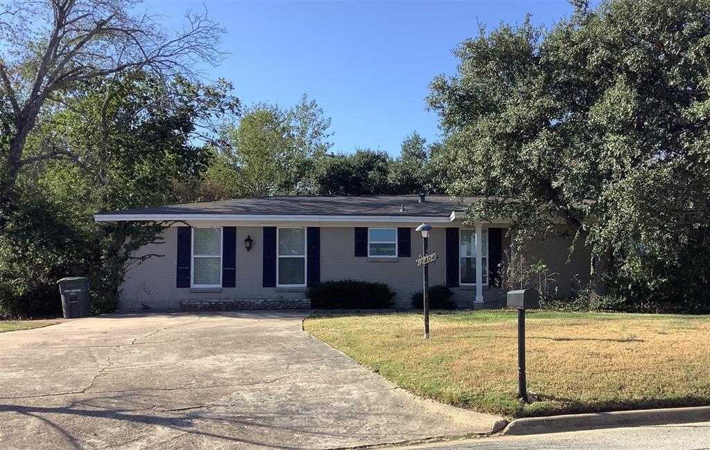 a house that has a tree in front of it