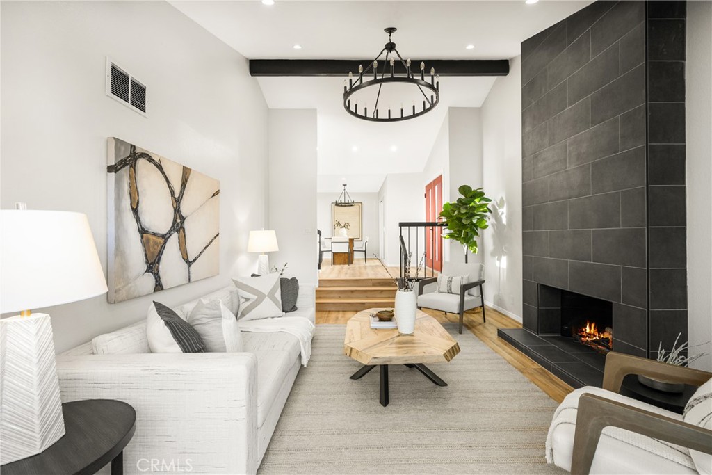 a living room with furniture kitchen and a fireplace