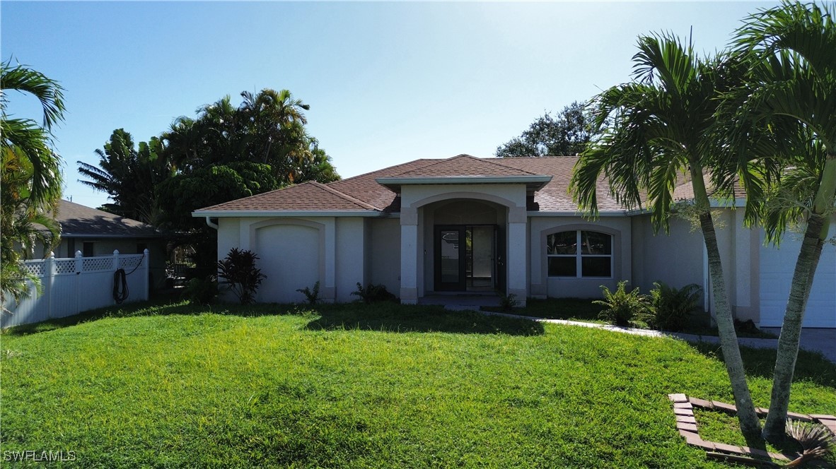 a view of house with backyard and garden