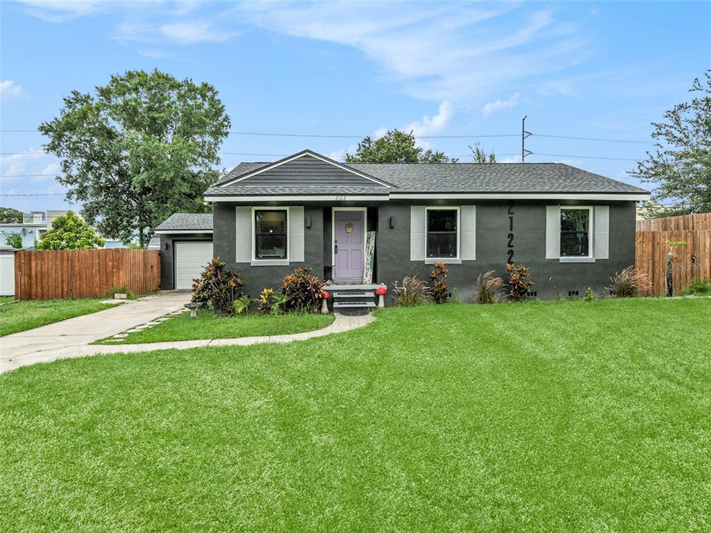 a front view of house with yard and outdoor seating