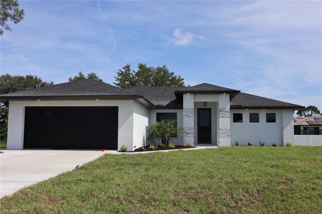 a front view of a house with a yard and garage