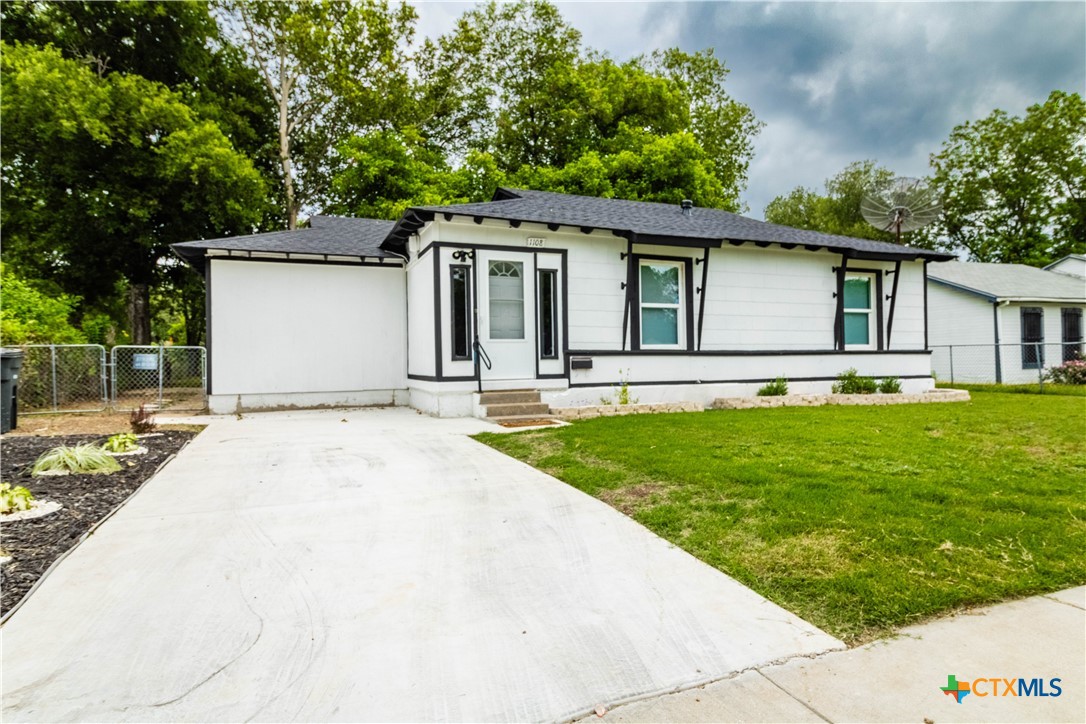 a front view of house with yard and green space