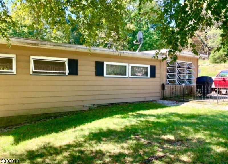 a backyard of a house with barbeque oven