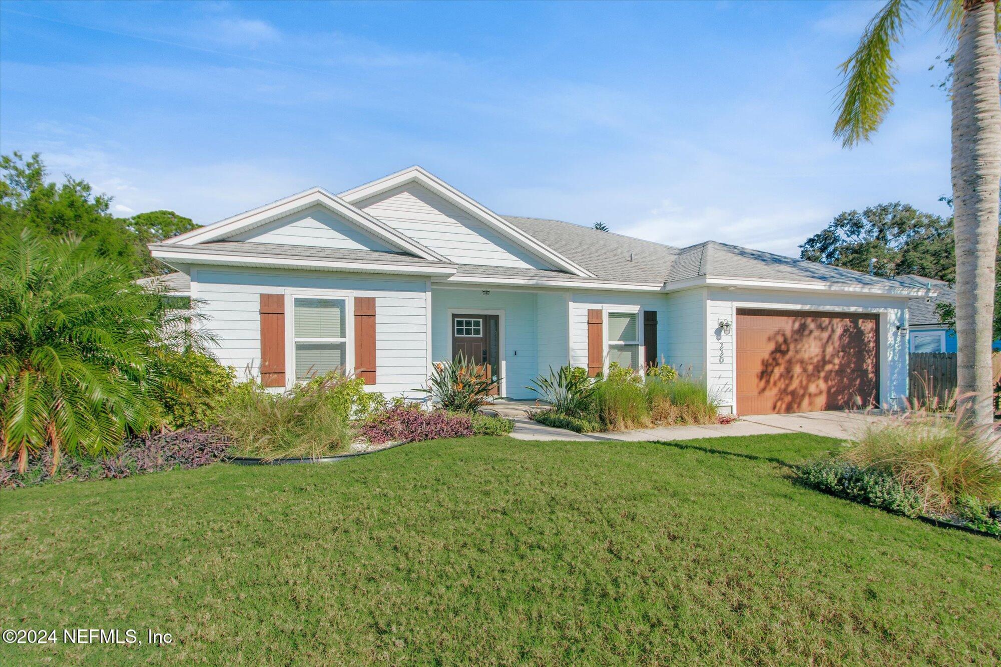 a front view of house with yard and green space