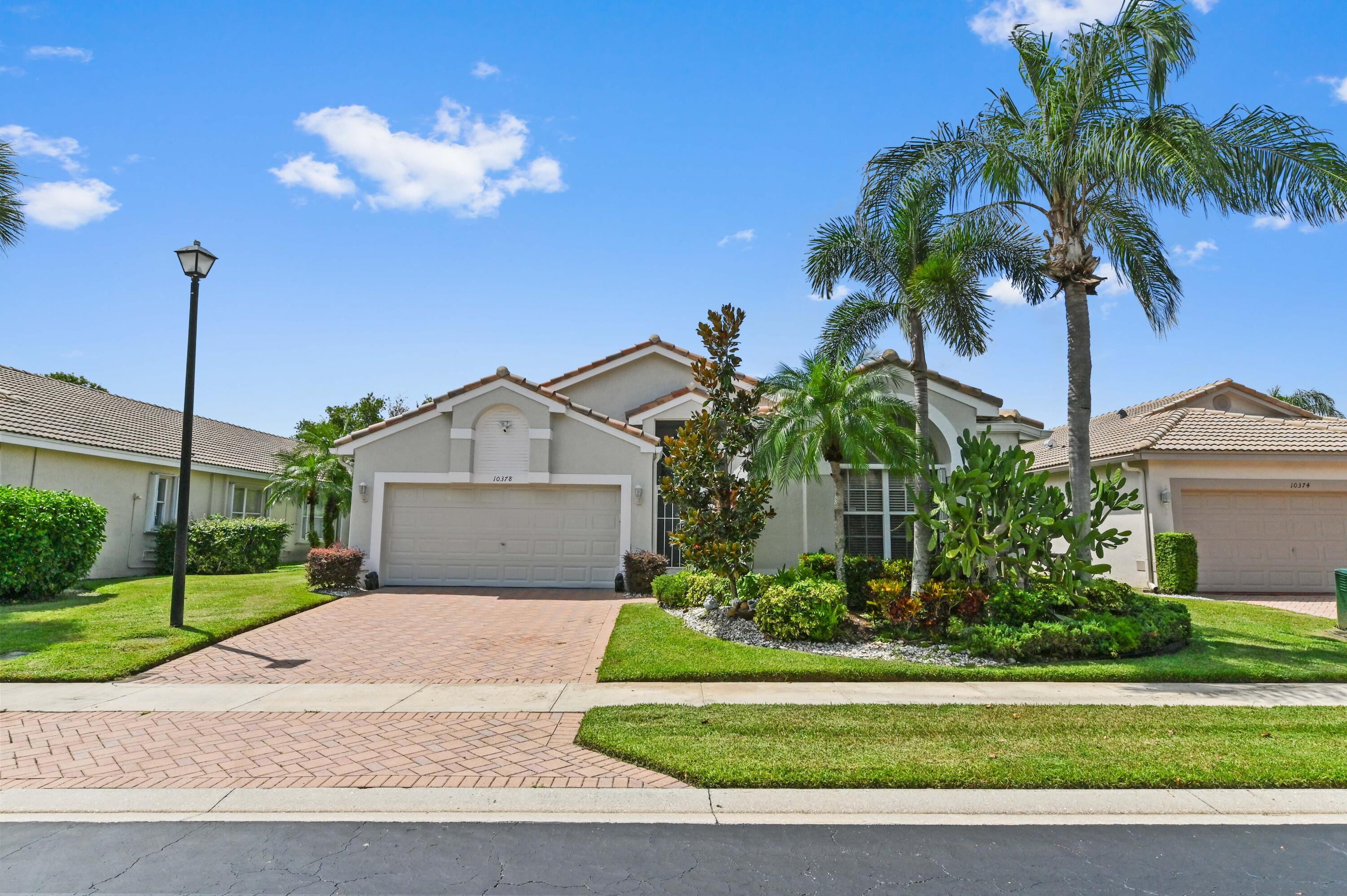 a front view of a house with a garden and a yard