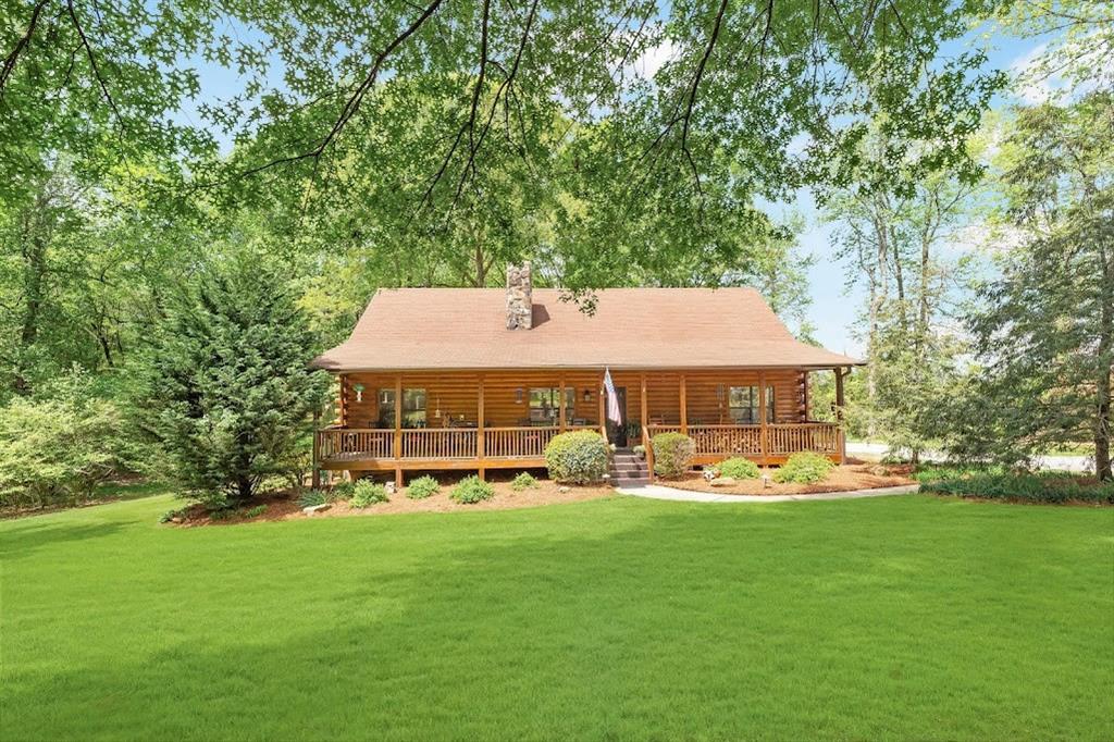 a aerial view of a house with garden space and trees