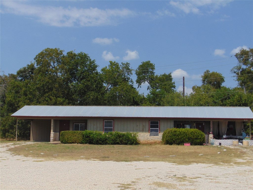 a front view of a building with a garden