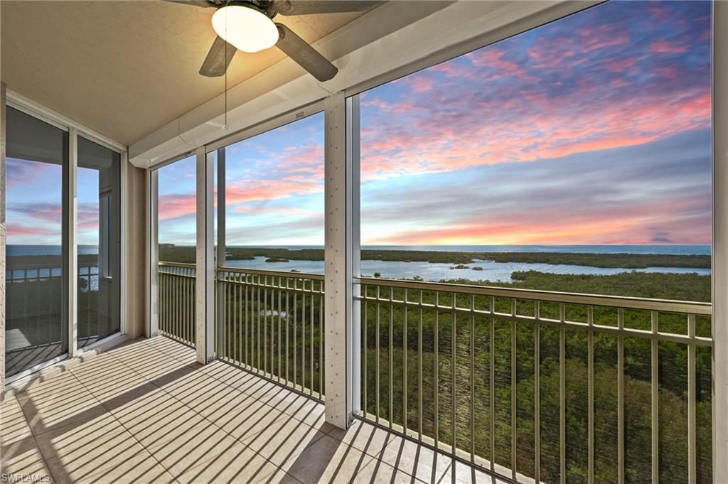 a view of a balcony with floor to ceiling windows with wooden floor