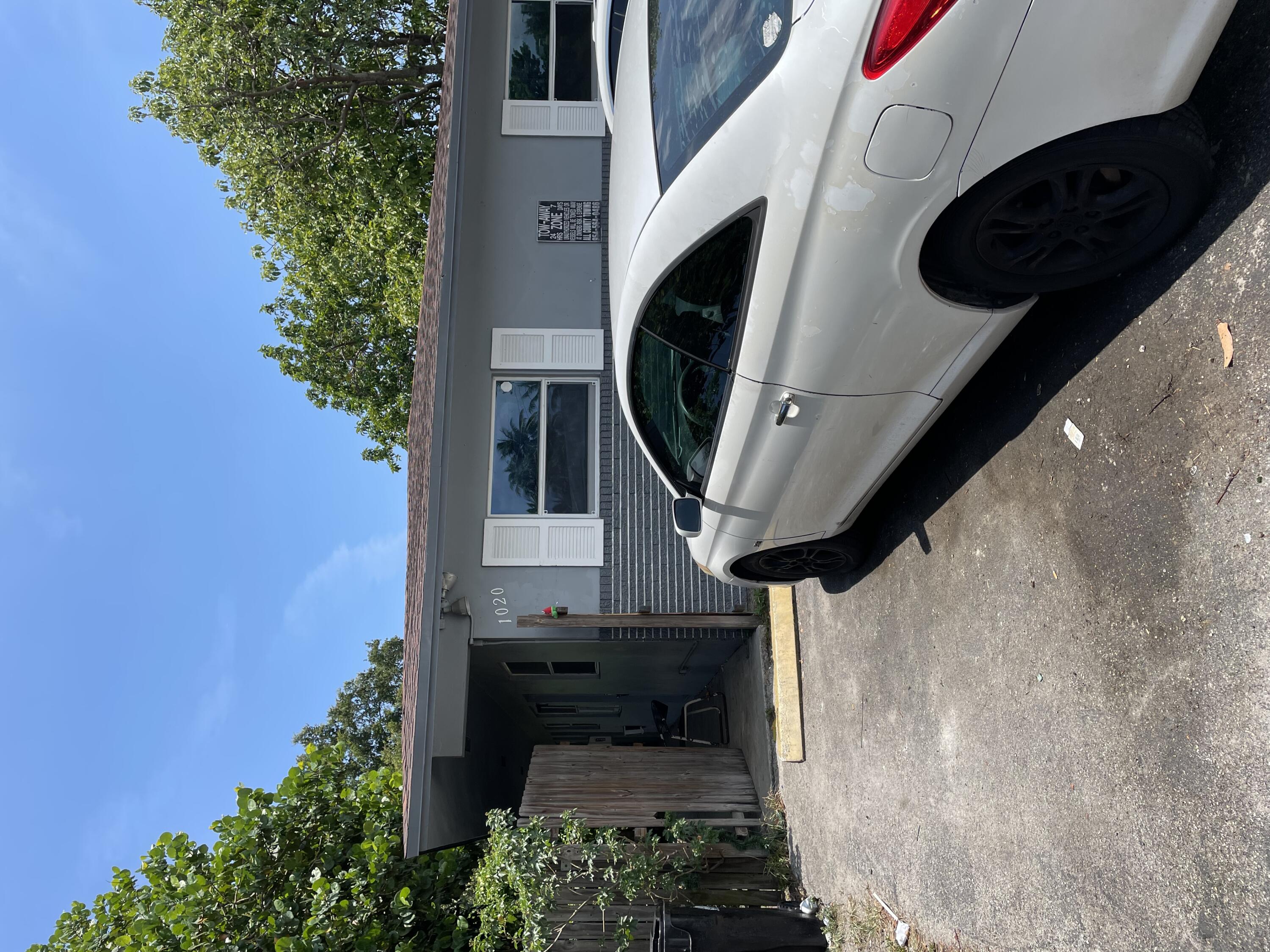 a view of a car parked in back yard of a house