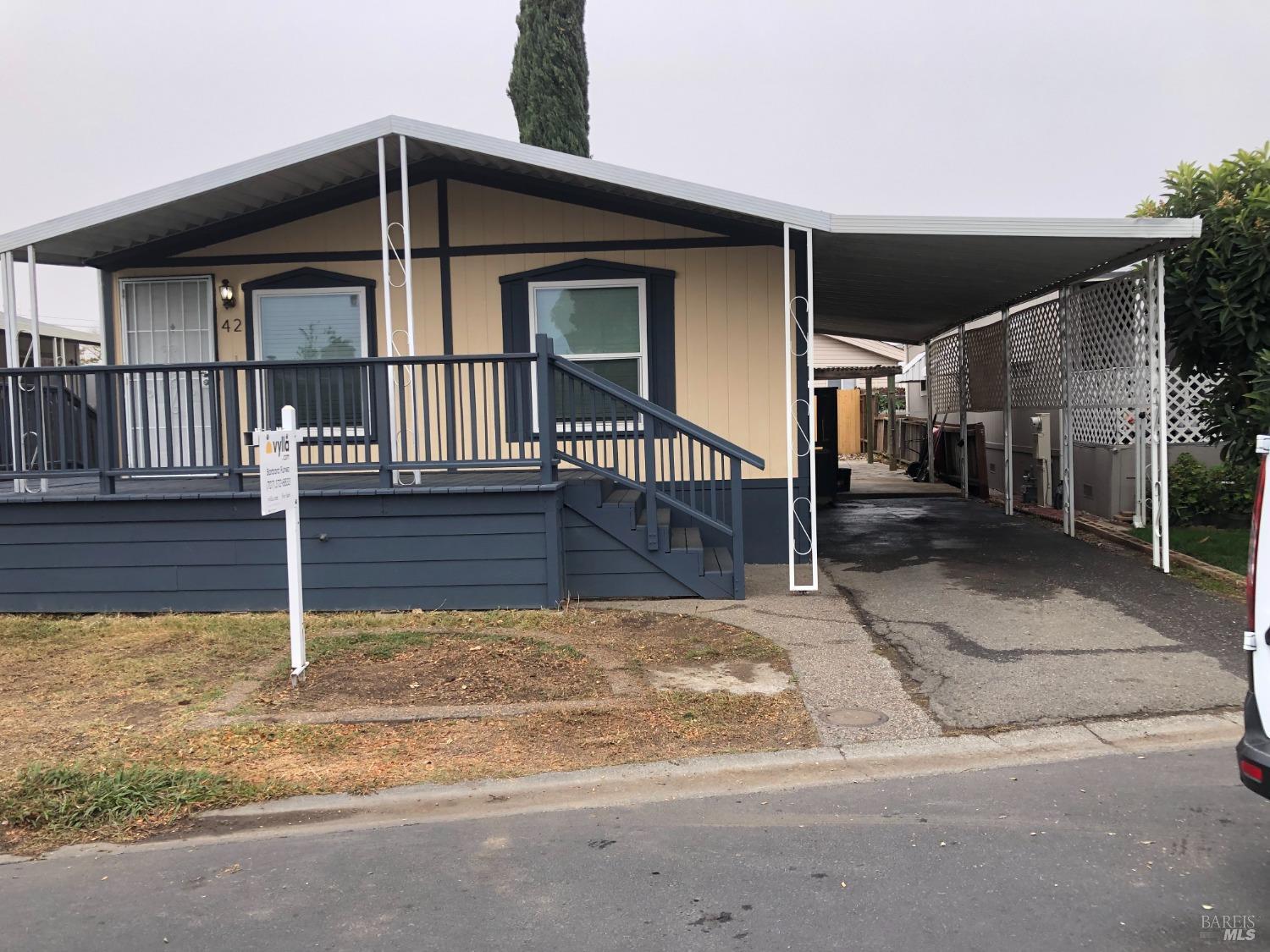 a front view of a house with wooden fence