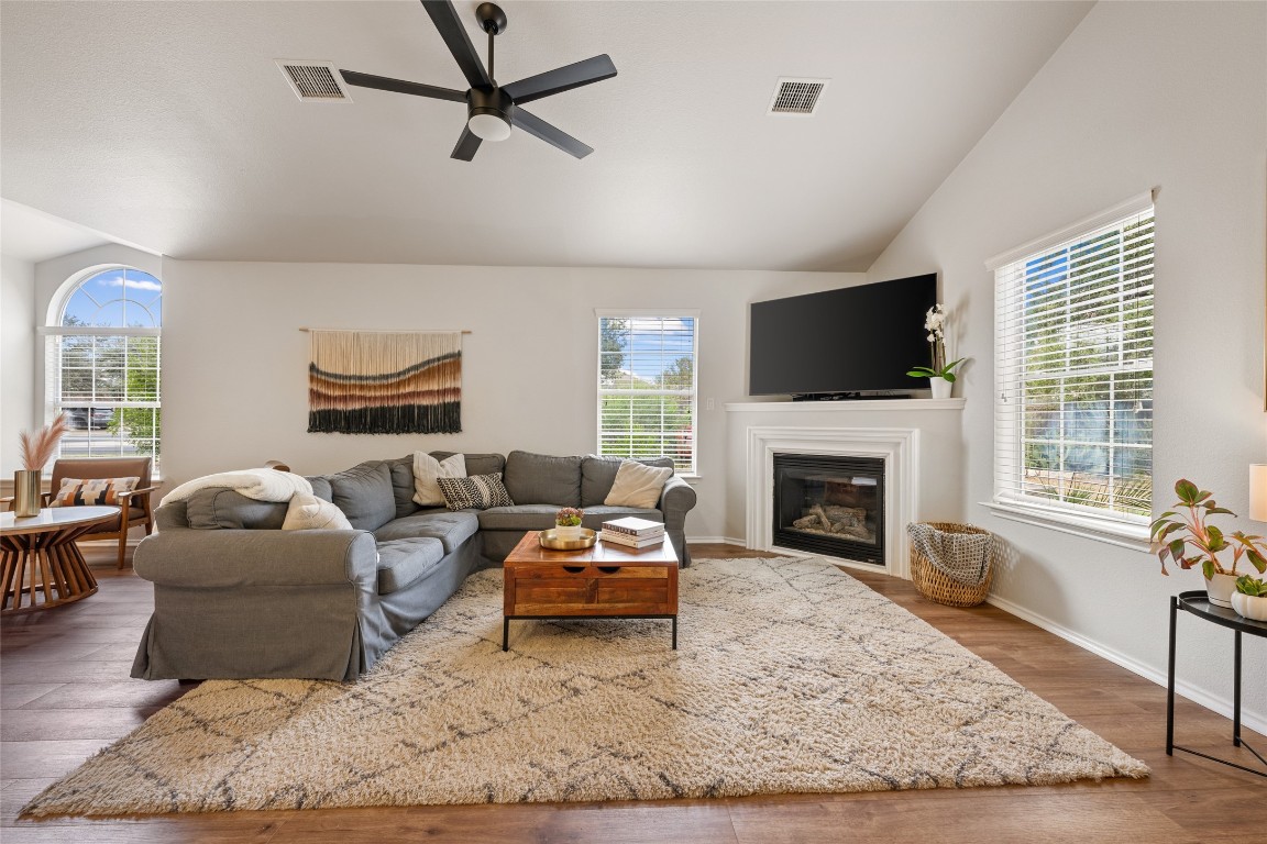 a living room with furniture fireplace and a flat screen tv