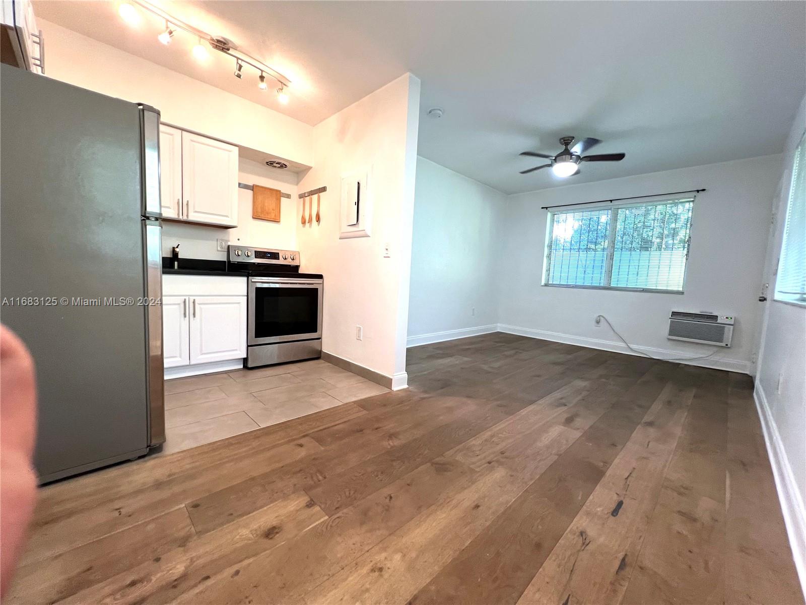 a view of a kitchen with a sink dishwasher and a refrigerator