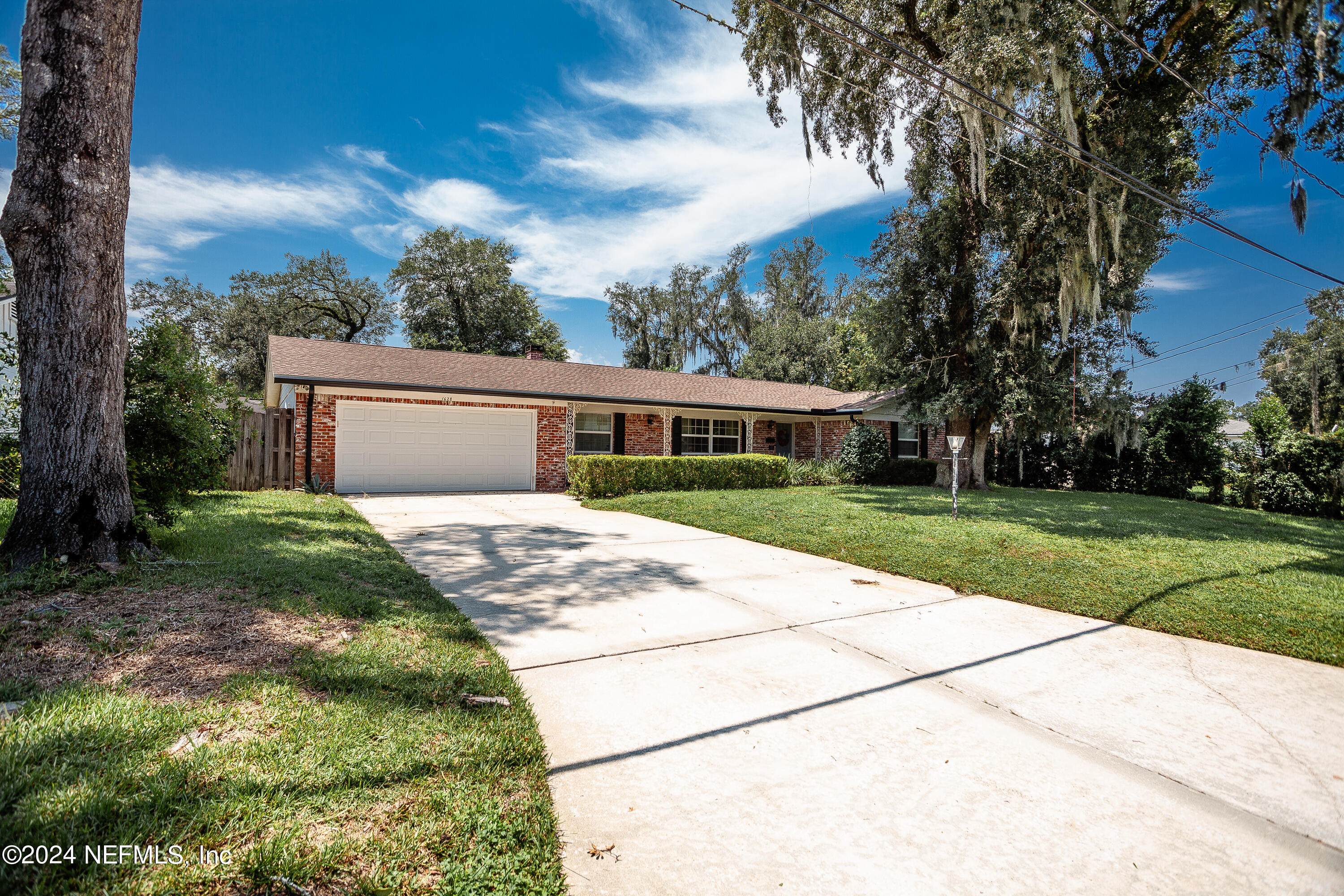 a front view of house with yard and green space