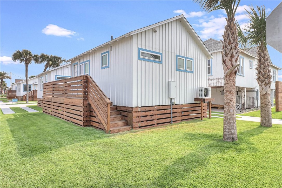 a view of a house with a yard and deck