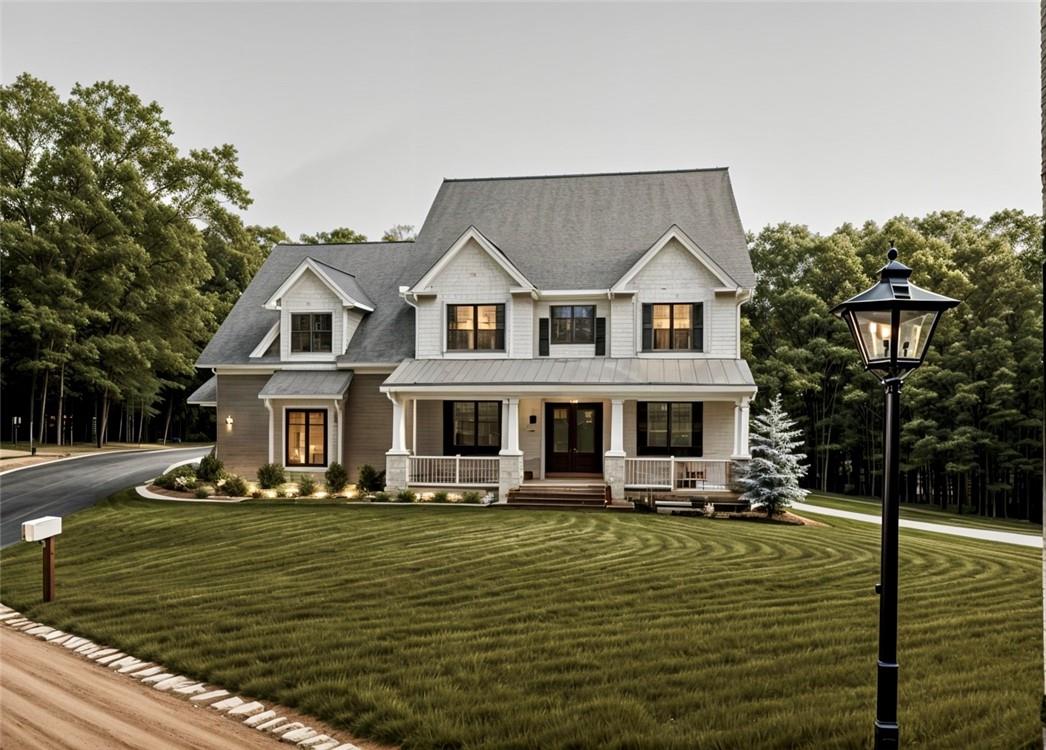 View of front of house with covered porch and a front lawn