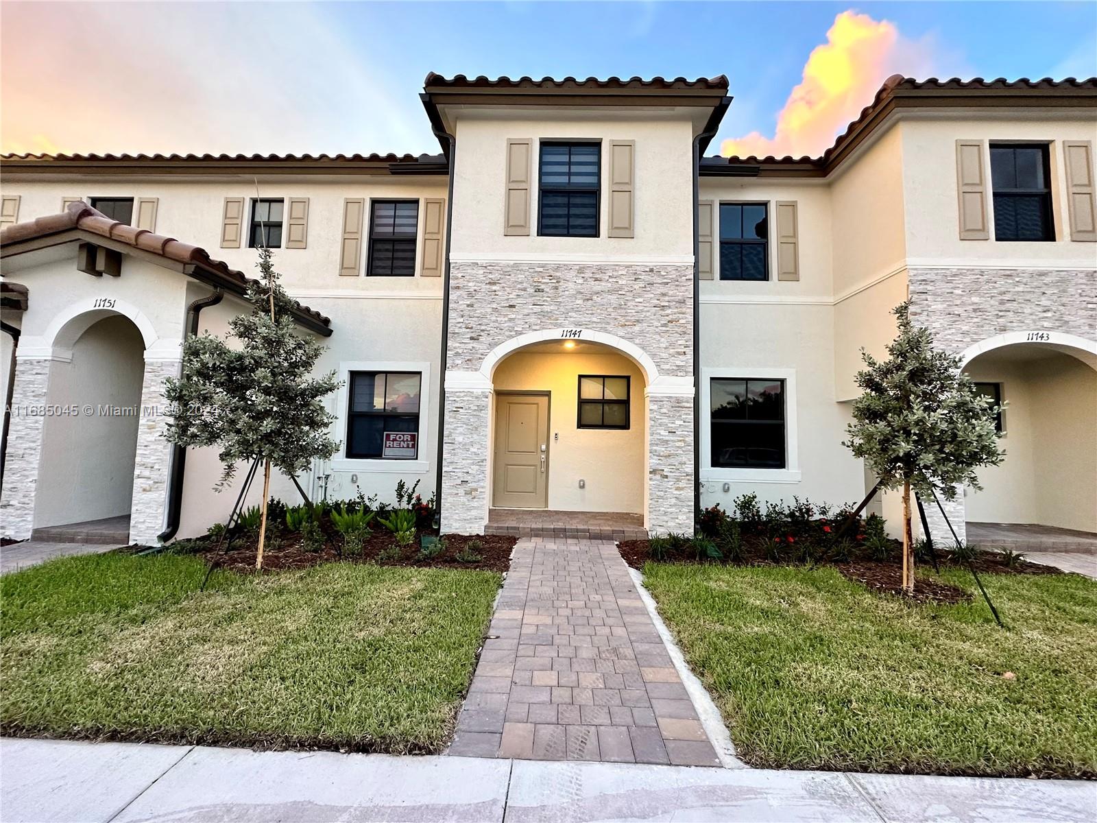 a front view of a house with a yard