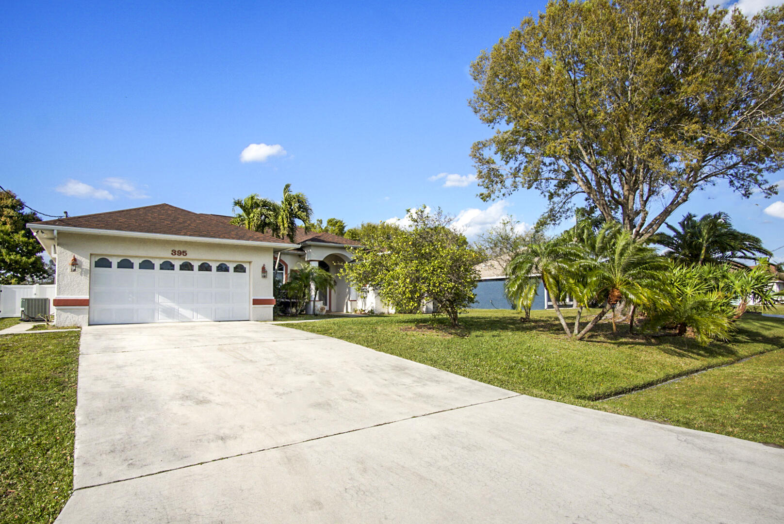 a view of a house with a yard and a garage