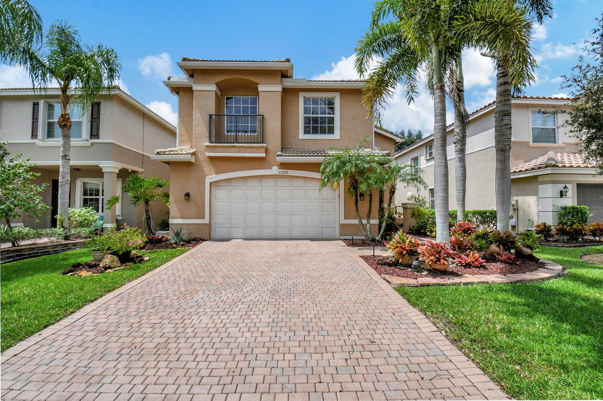 a front view of a house with a yard and a garage