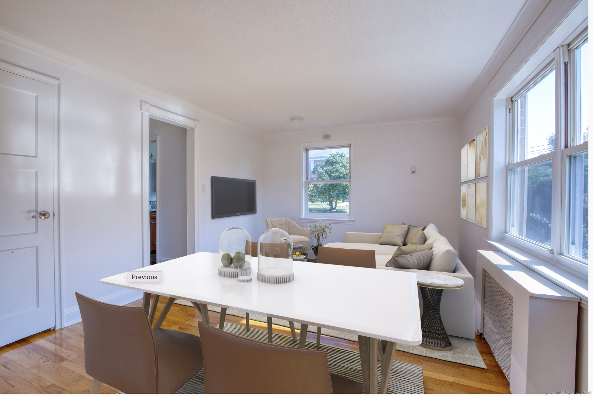 a view of a dining room with a table and chairs