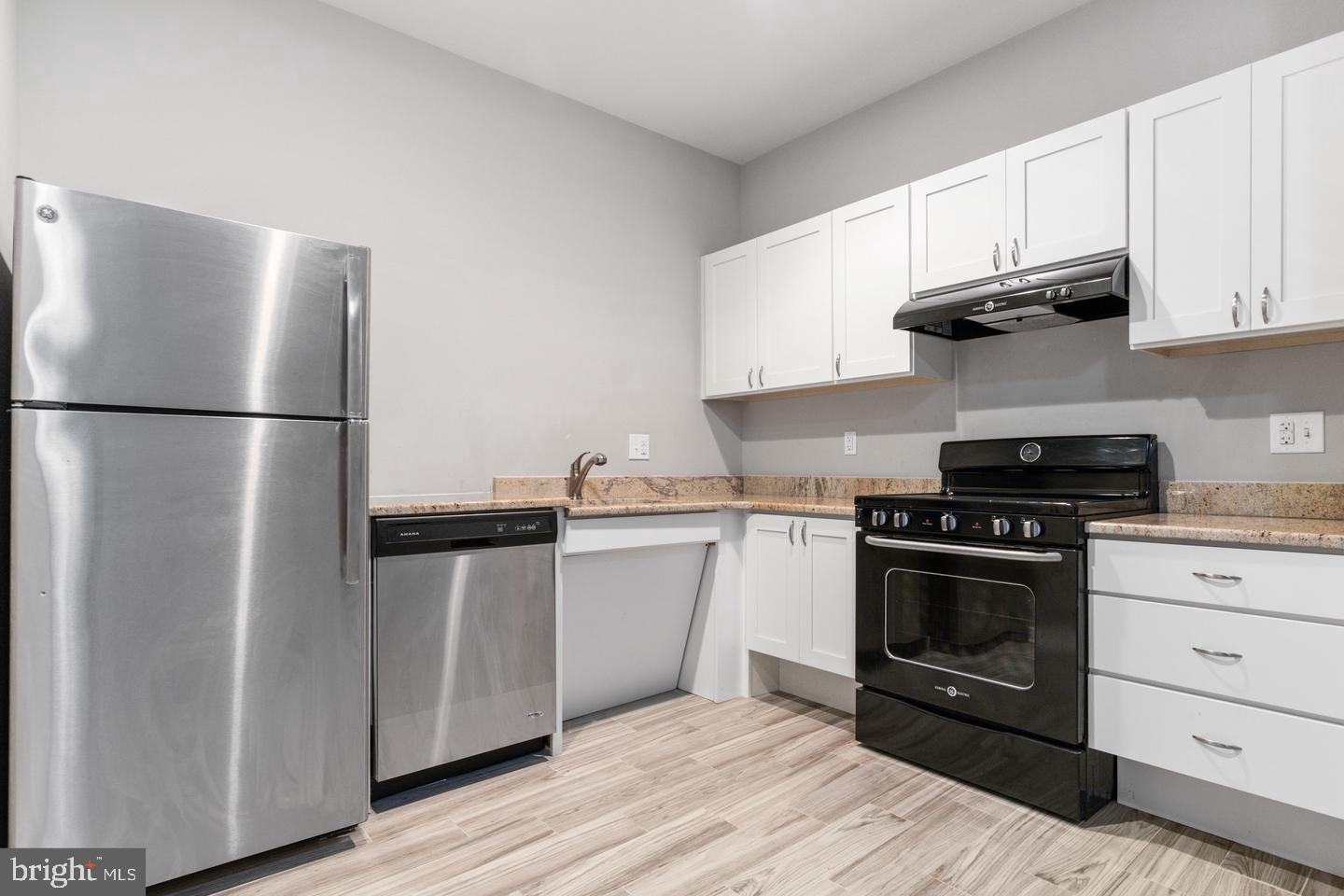 a kitchen with a white stove and refrigerator