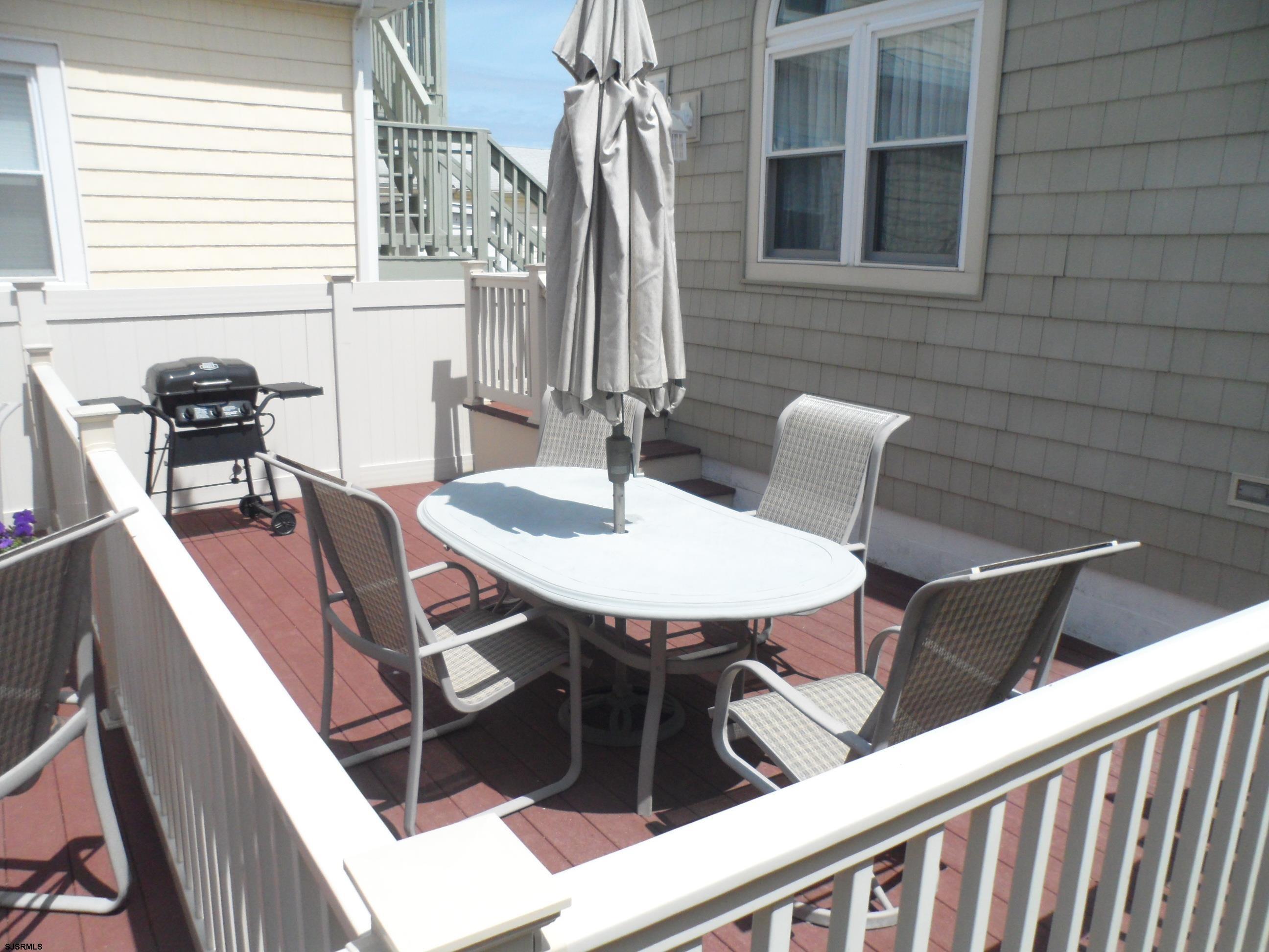 a view of a chairs and table in the balcony