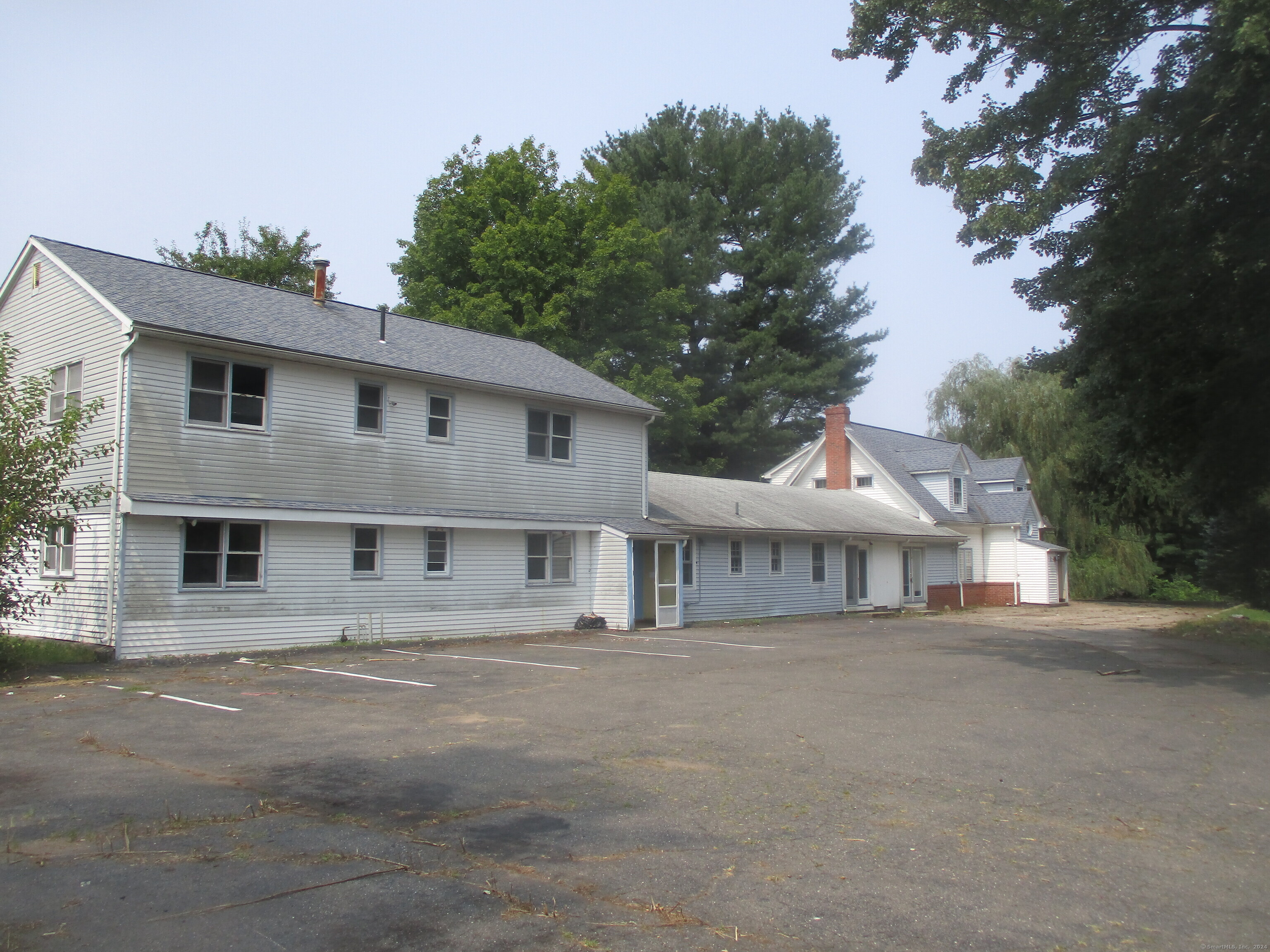 a view of house with a tree in front of it